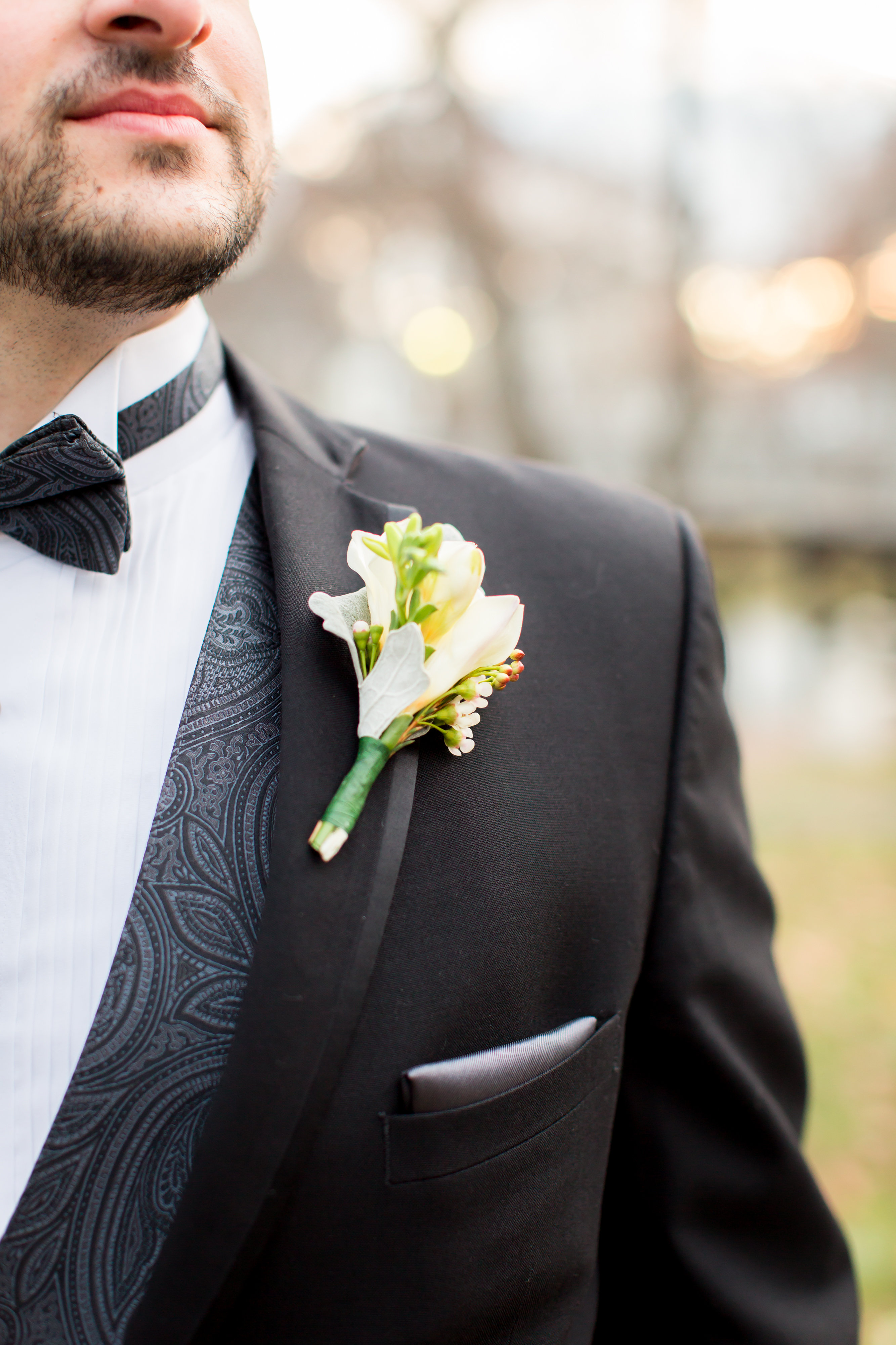 boutonnieres with freesia and wax flower